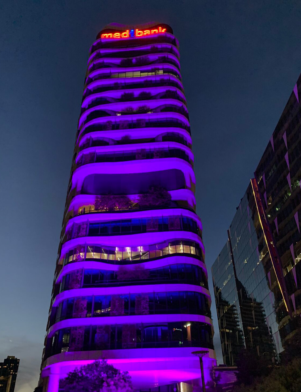 Purple lighting along an office tower during the campaign against violence against women.