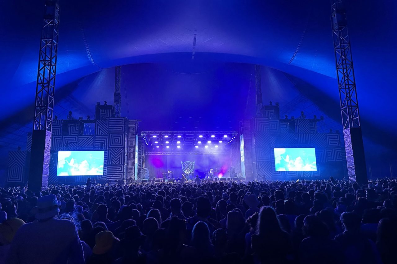 Blue lighting over the Spilt Milk stage and audience.