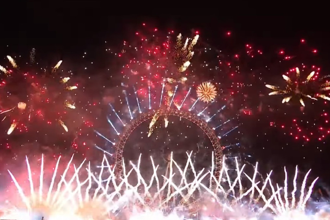 Fireworks and white beams above the London Eye during New Year celebrations.