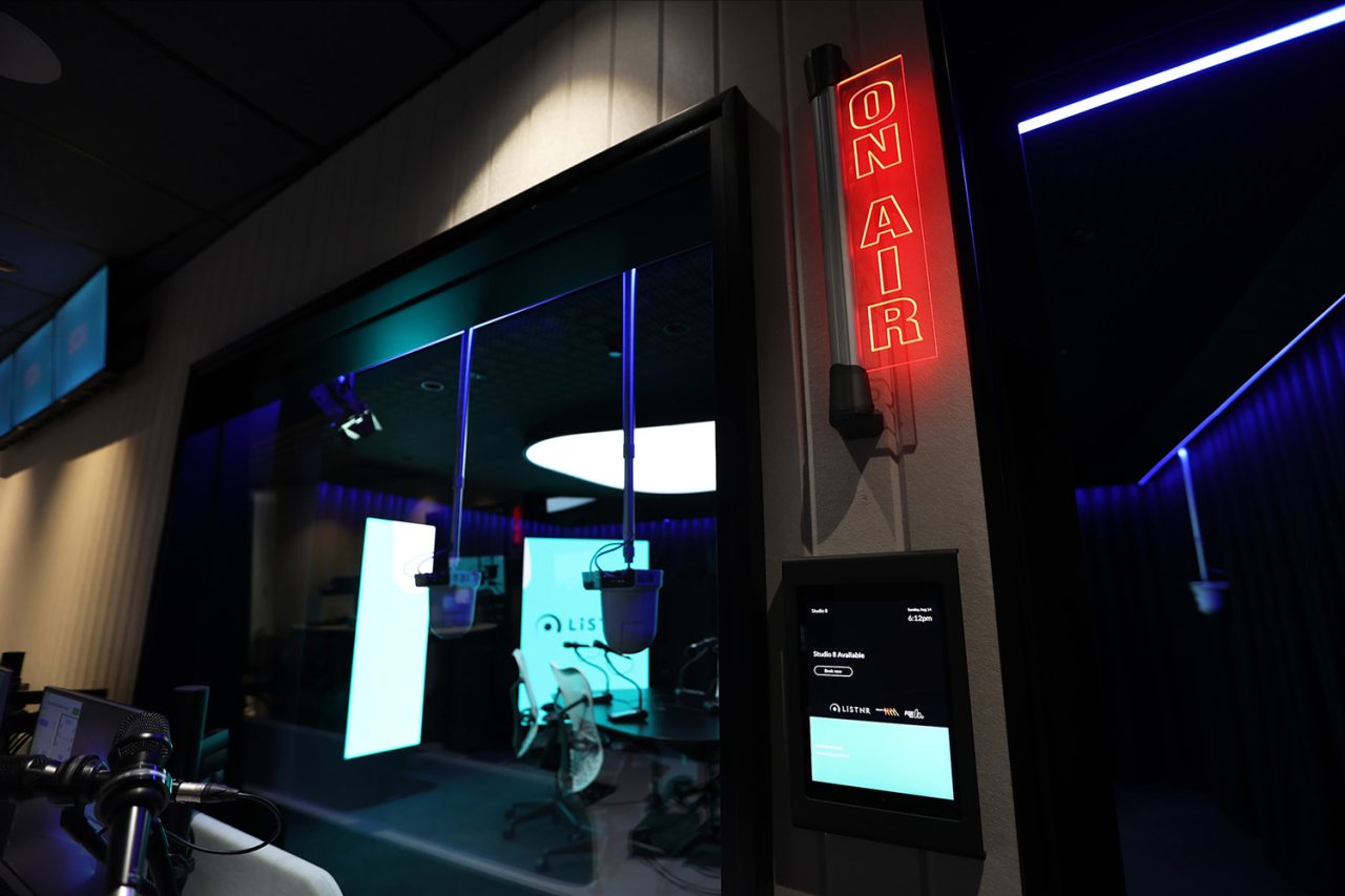Red On Air sign beside a glass-fronted Southern Cross Austereo studio.