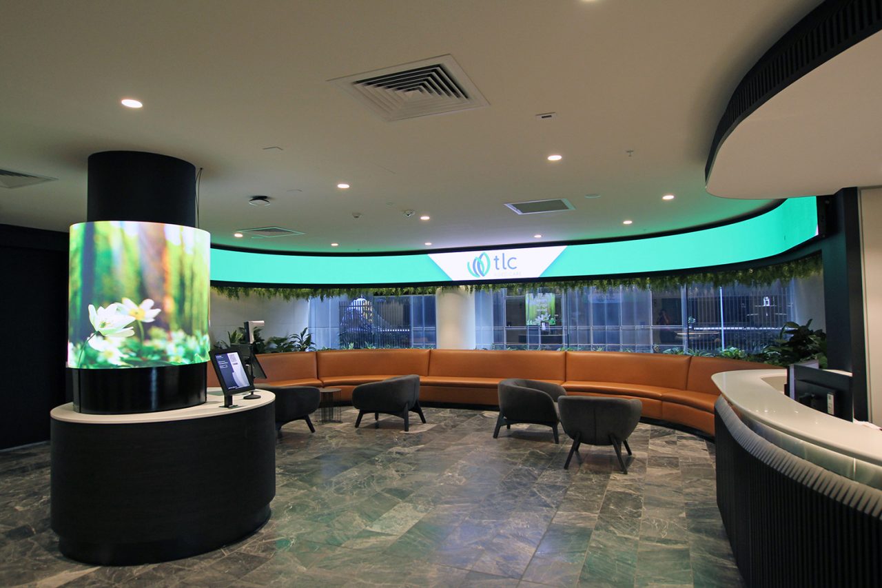 Green ribbon and column displays in TLC Aged Care reception.