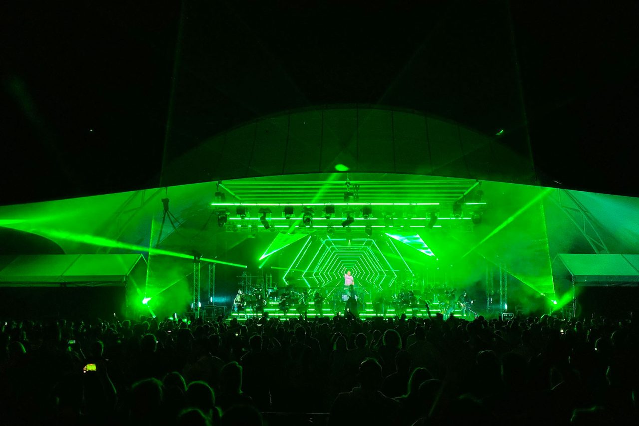 Green lighting beams across the Ministry of Sound Orchestral stage and audience in Canberra.