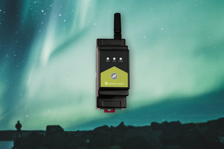 LumenRadio Galileo wireless DMX unit against an aurora background.