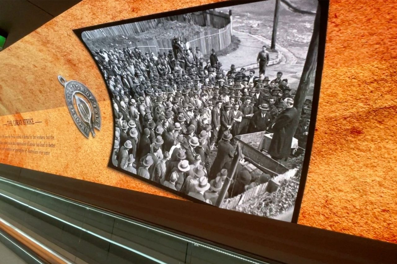 LED wall in South Eveleigh’s Foundry Tunnel displaying a historic crowd photograph.