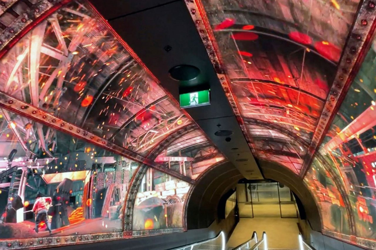 Industrial imagery across the curved digital walls and ceiling of South Eveleigh's Foundry Tunnel.
