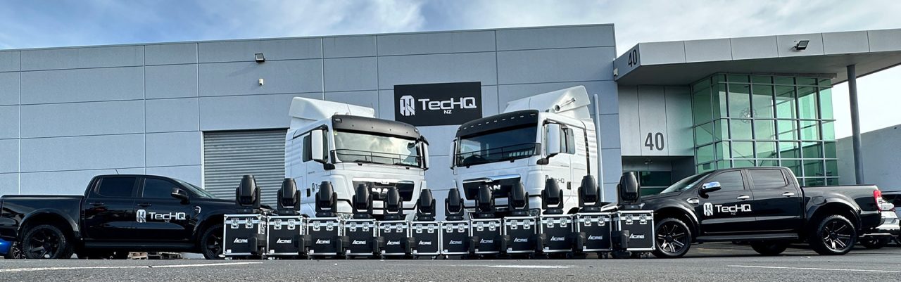 Lighting fixtures displayed in front of TecHQ's building and production vehicles.