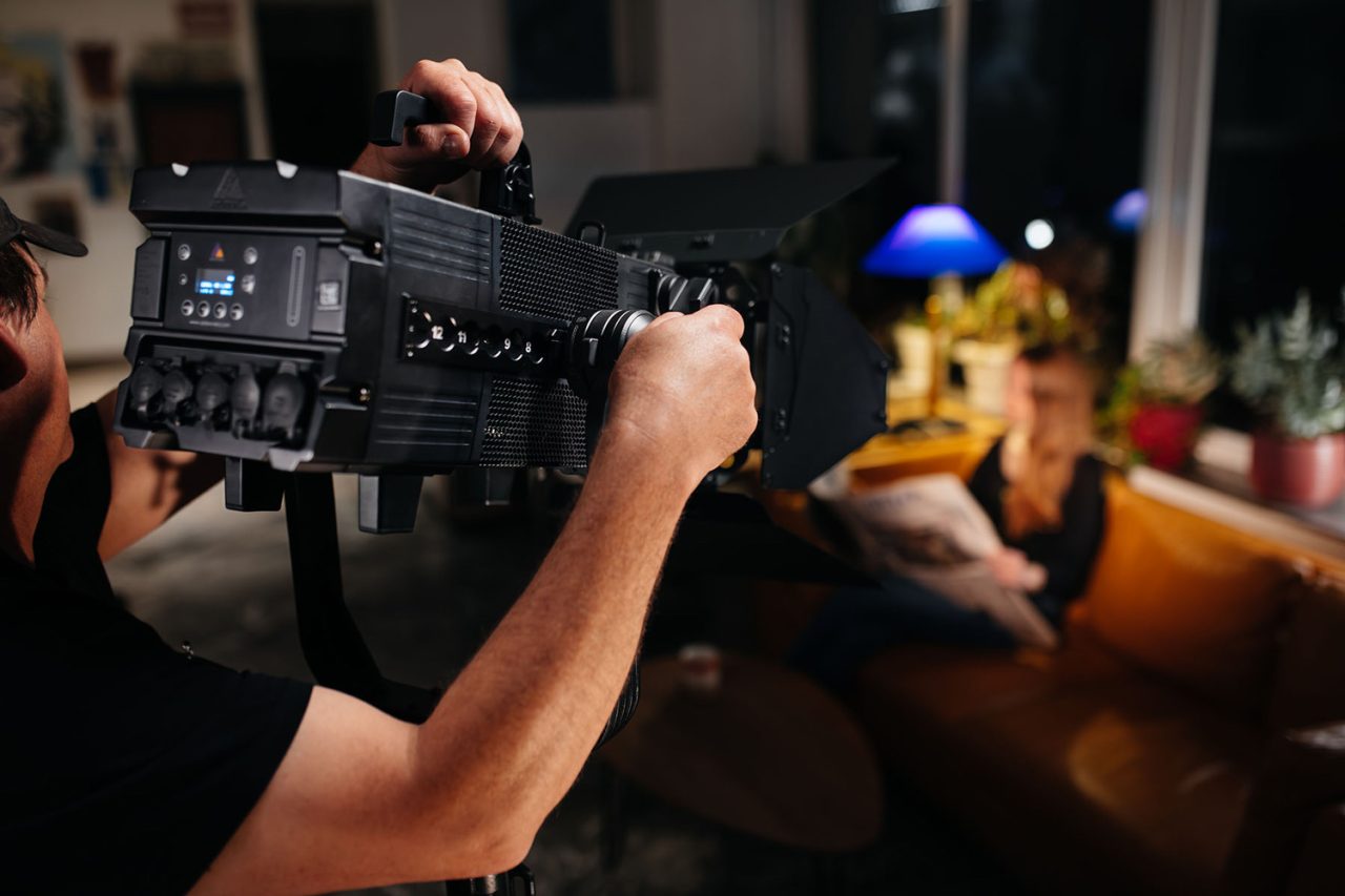 Technician adjusts the rear controls on an Astera Fresnel fixture.