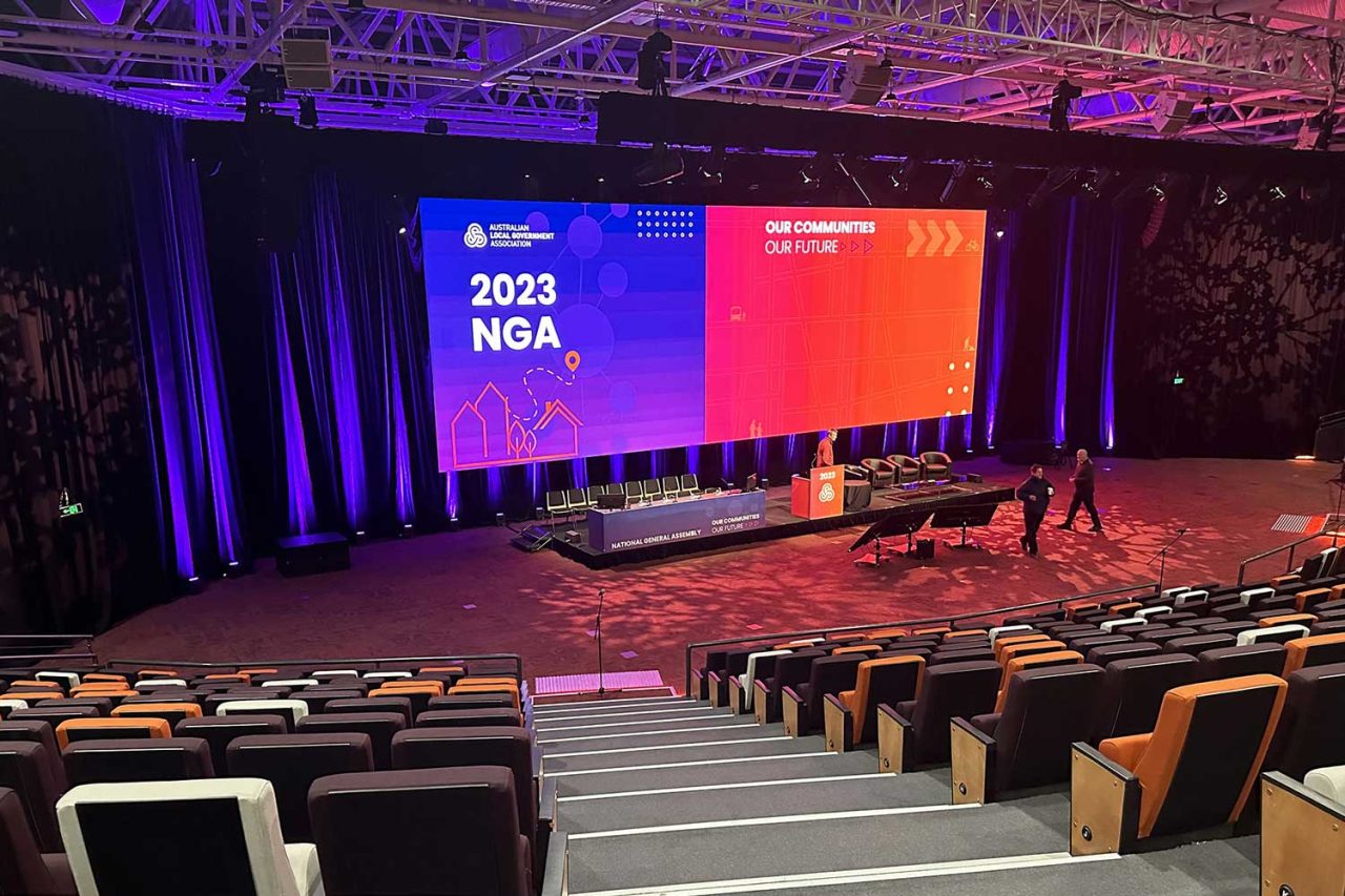 Auditorium seating facing the wide digital backdrop at the 2023 NGA conference.
