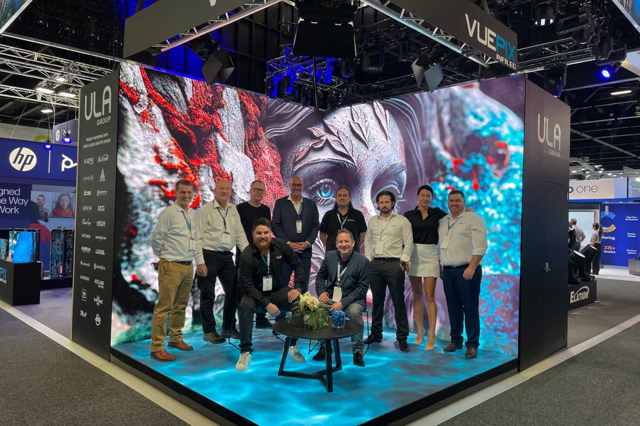 ULA team in front of a large digital wall at Integrate 2023.