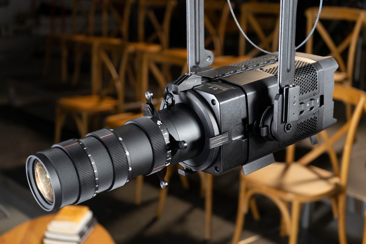 Astera PlutoFresnel fitted with a long Projection Lens attachment on a lighting rig.