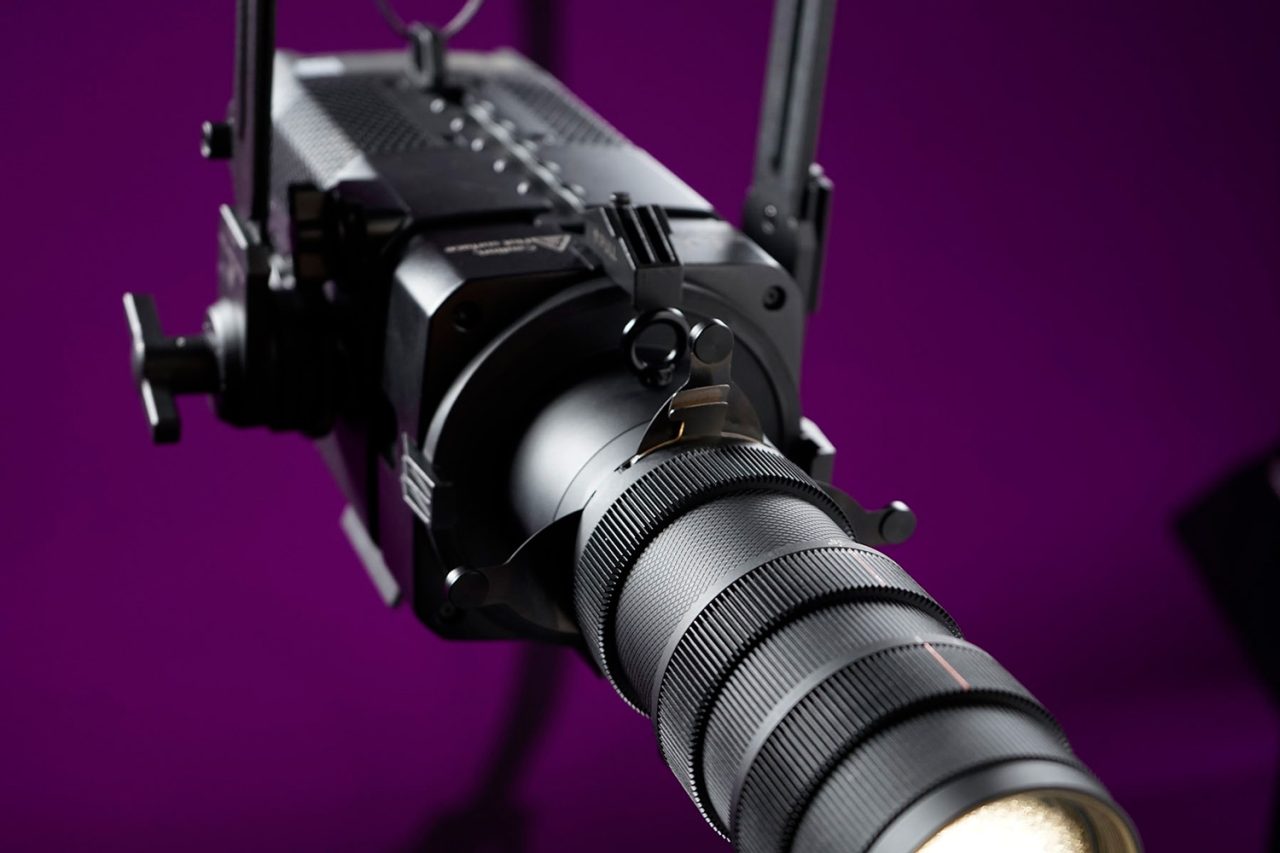 Astera fixture with a Projection Lens attachment emitting a narrow white beam.