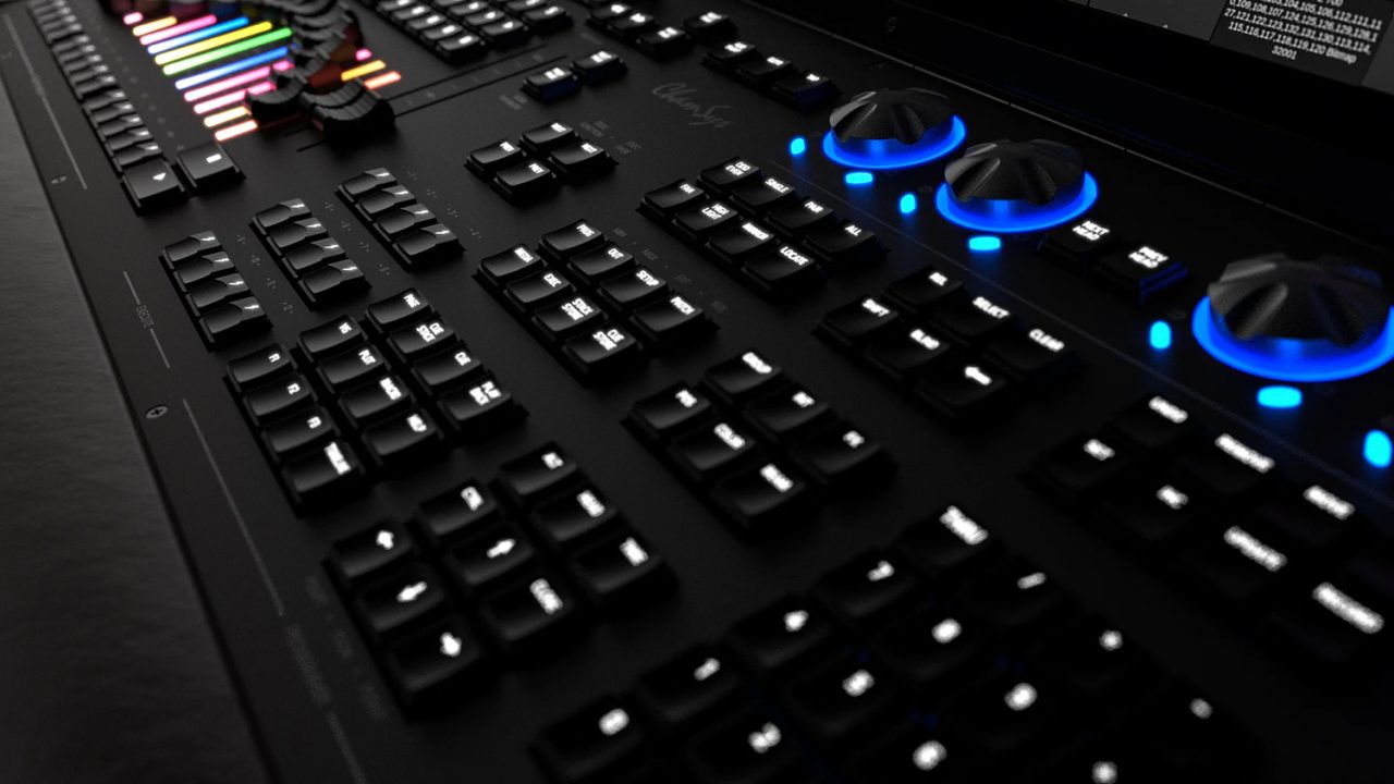 Illuminated buttons and blue rotary controls on the ChamSys MQ500M+ console.
