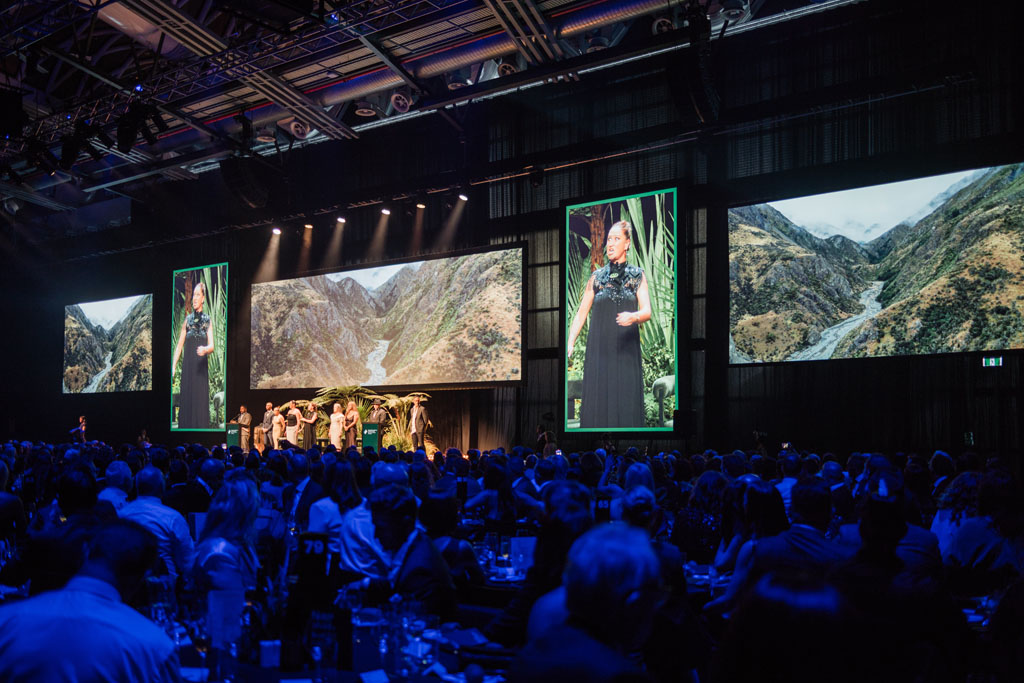 Audience facing panoramic landscape screens at the 2024 New Zealander of the Year event.