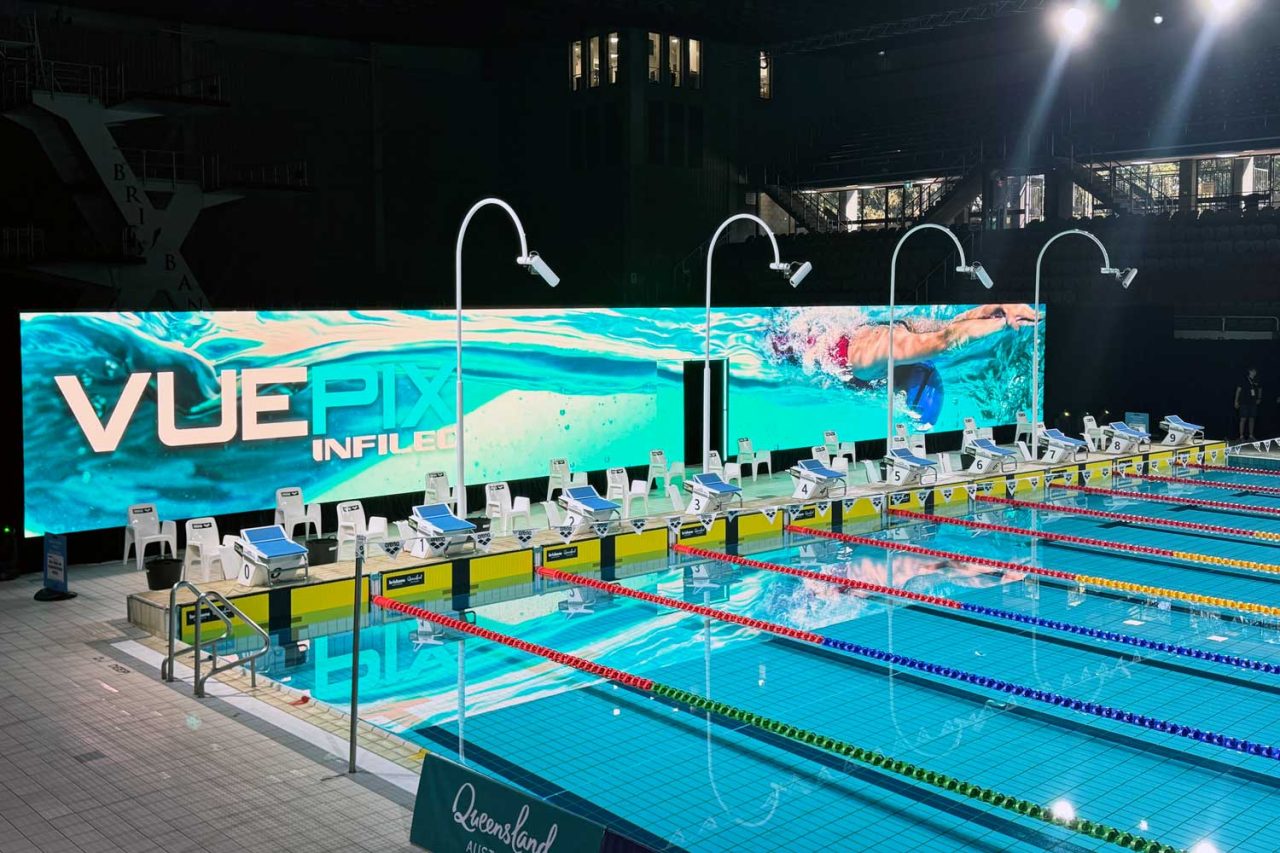 VuePix Infiled branding on the long poolside screen at the 2024 Australian swimming trials.