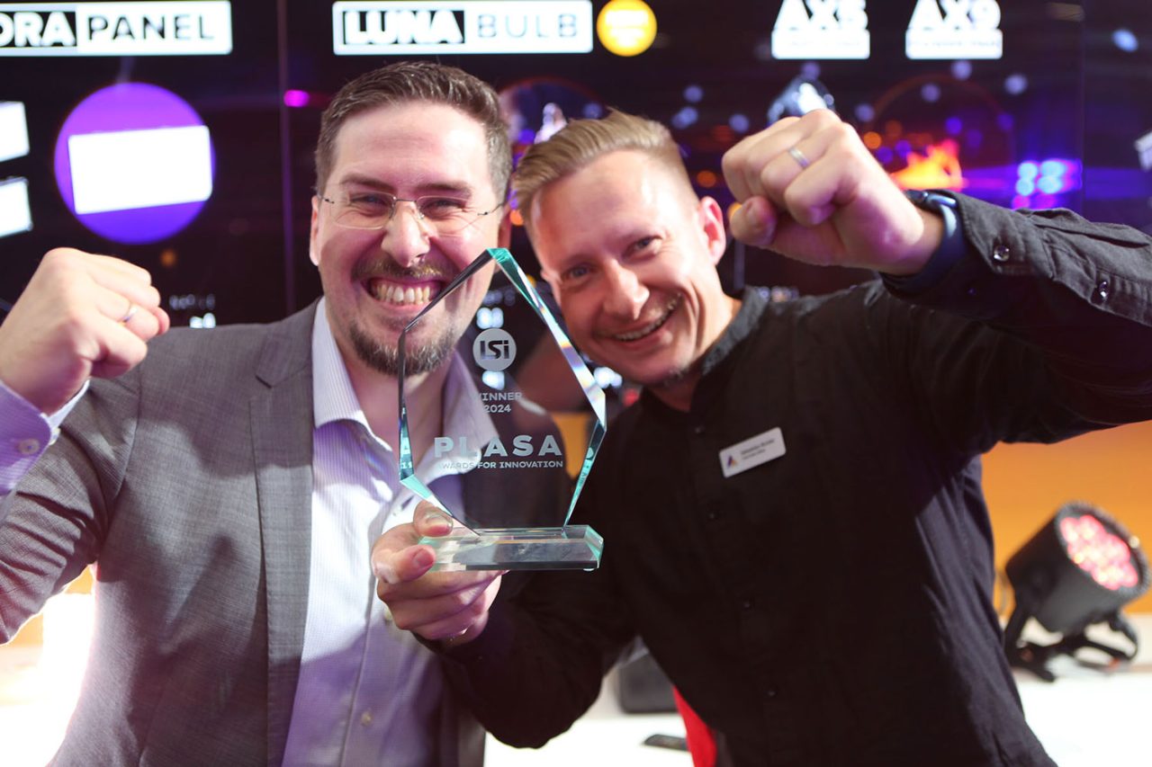 Two Astera team members holding the LunaBulb PLASA Innovation Award.