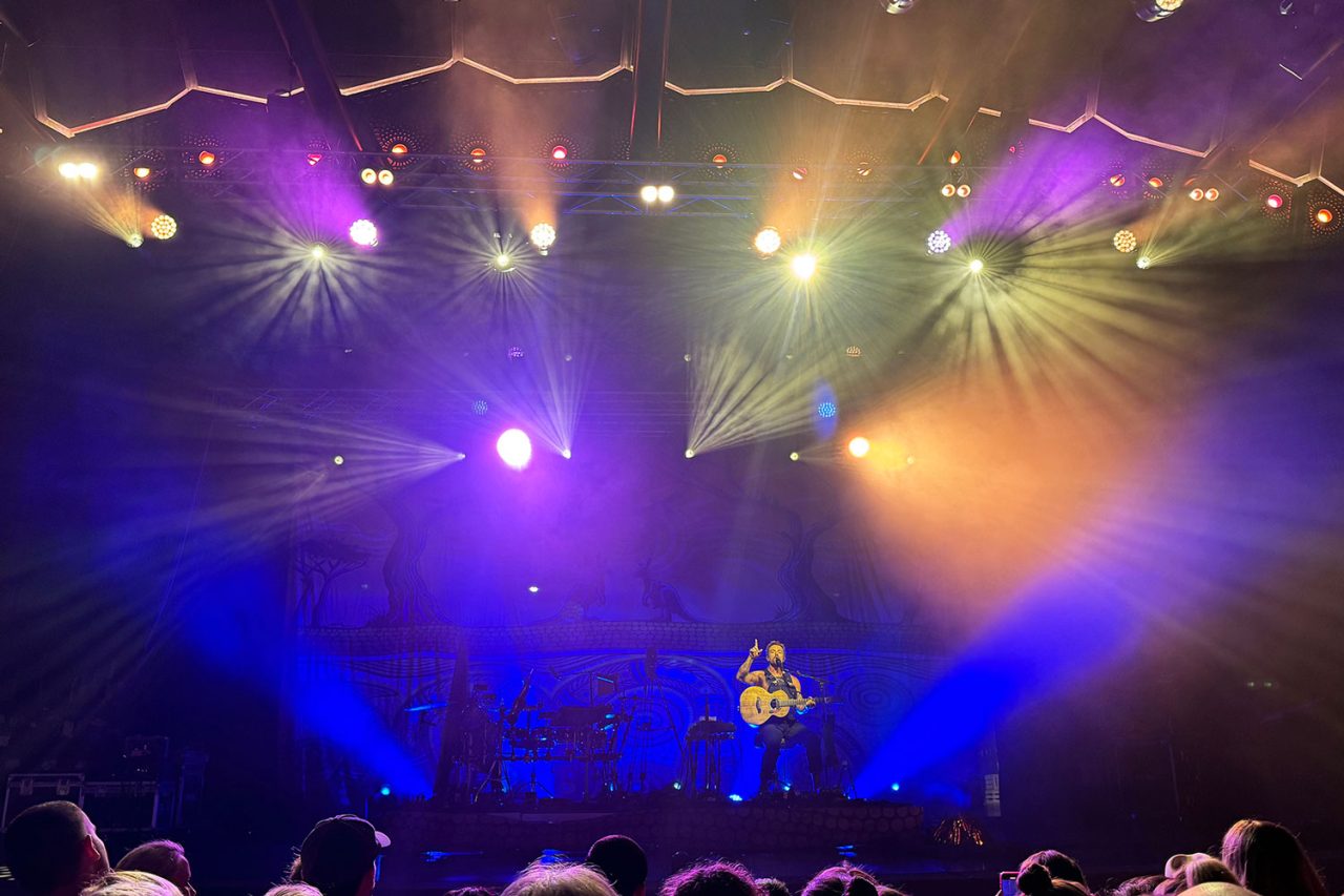 Purple, blue and yellow beams above the stage during Xavier Rudd's Freedom Sessions show.