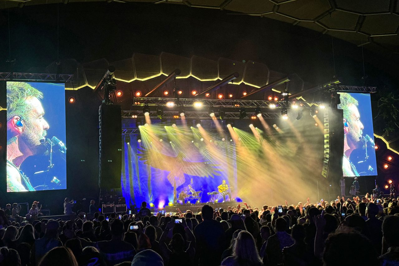 Wide view of the audience and live side screens during Xavier Rudd's Freedom Sessions show.
