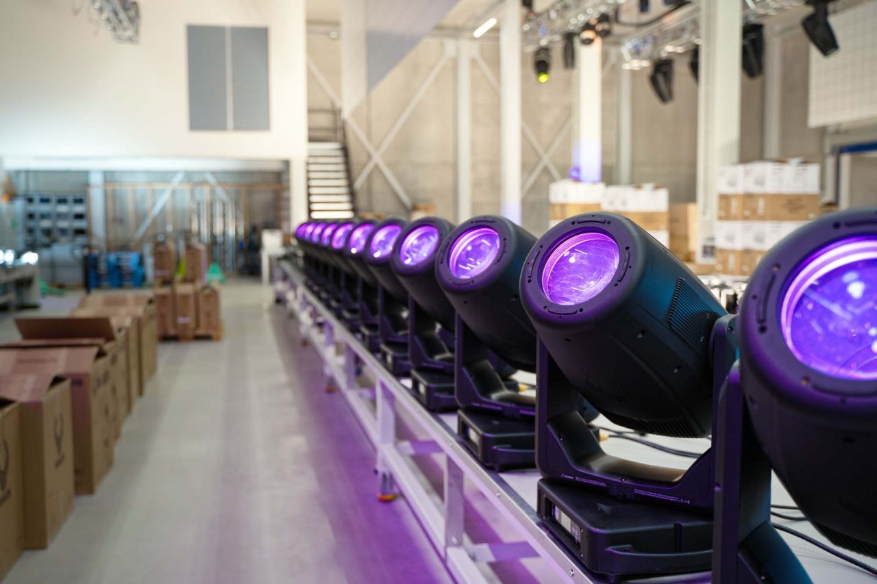 Row of Elation Paragon fixtures with purple lenses in a bright interior.