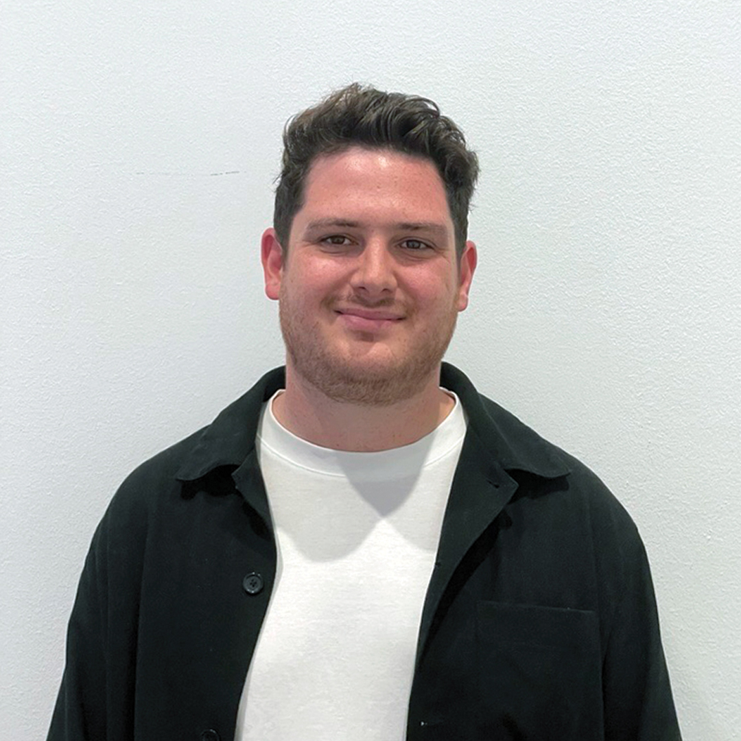 Portrait of Jory in a black overshirt and white T-shirt.