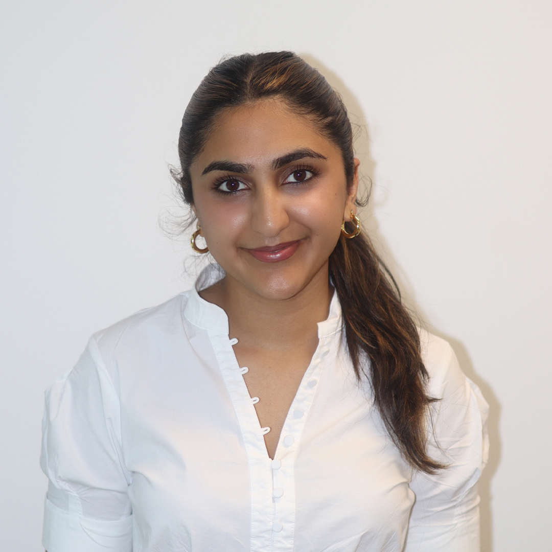 Portrait of Kajal in a white blouse.