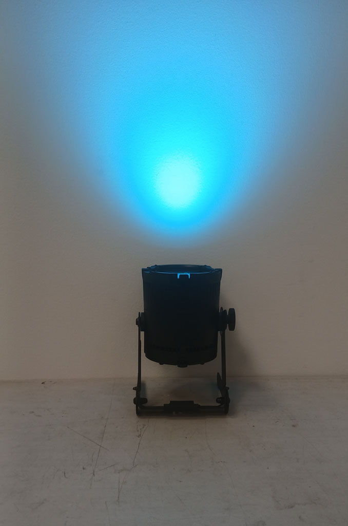Astera QuikSpot casting a cyan wash onto a white wall.