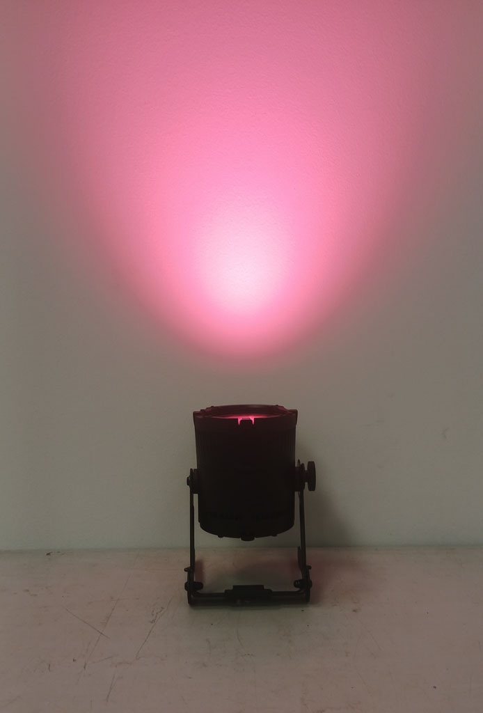Astera QuikSpot casting a pink wash onto a white wall.