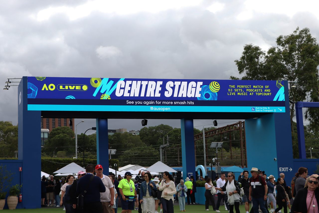 Visitors beneath the Australian Open Centre Stage entrance display.