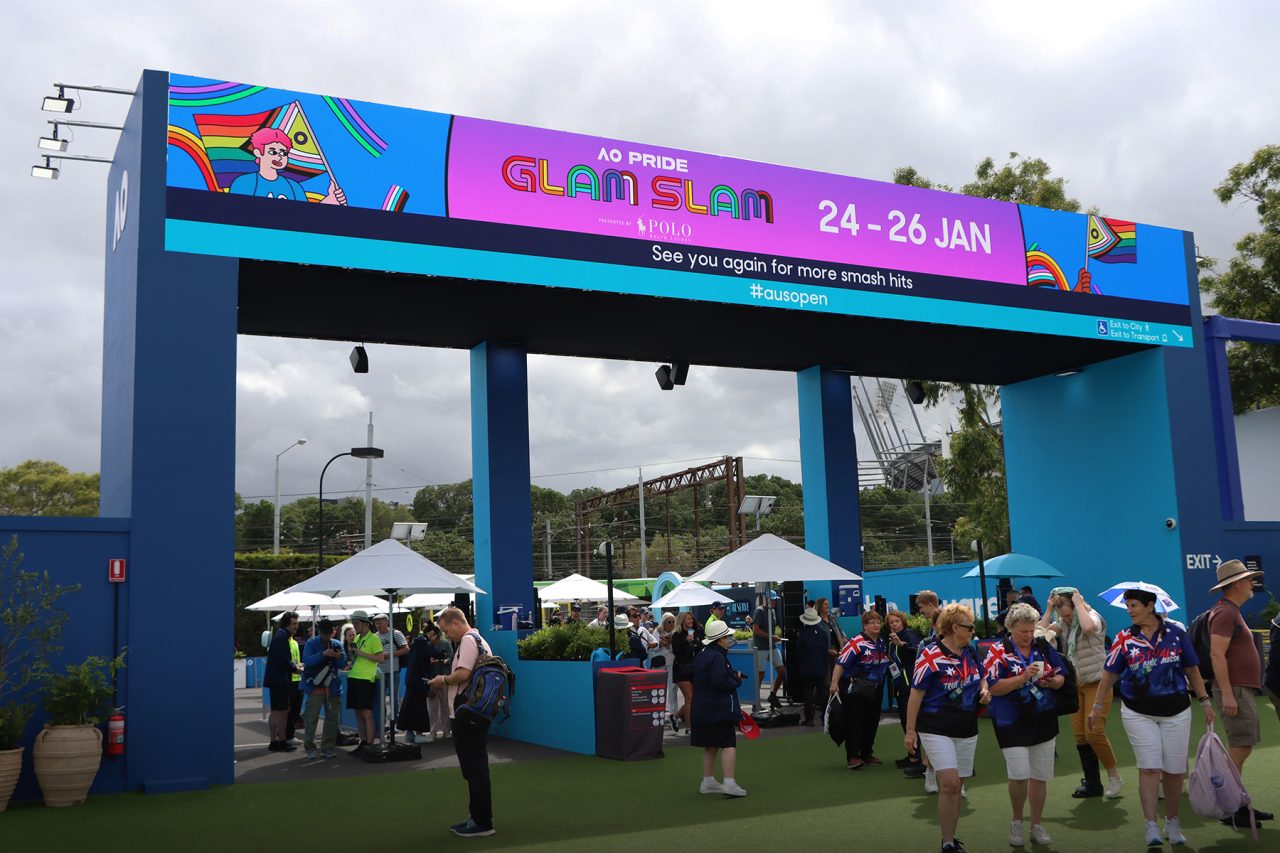 Wide digital arch displaying event information above visitors at the 2025 Australian Open.