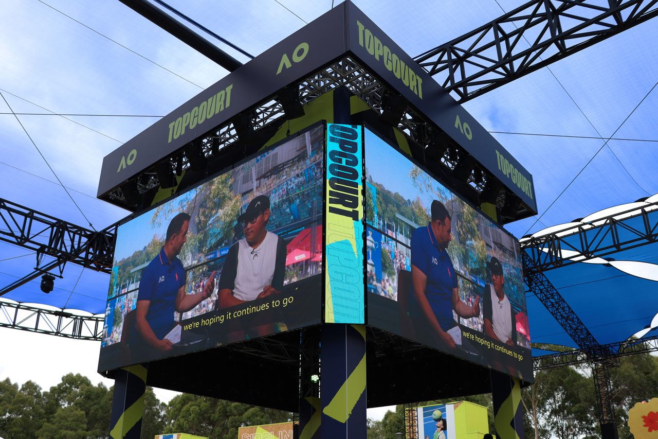 Corner view of the suspended video screens around the Topcourt stage.
