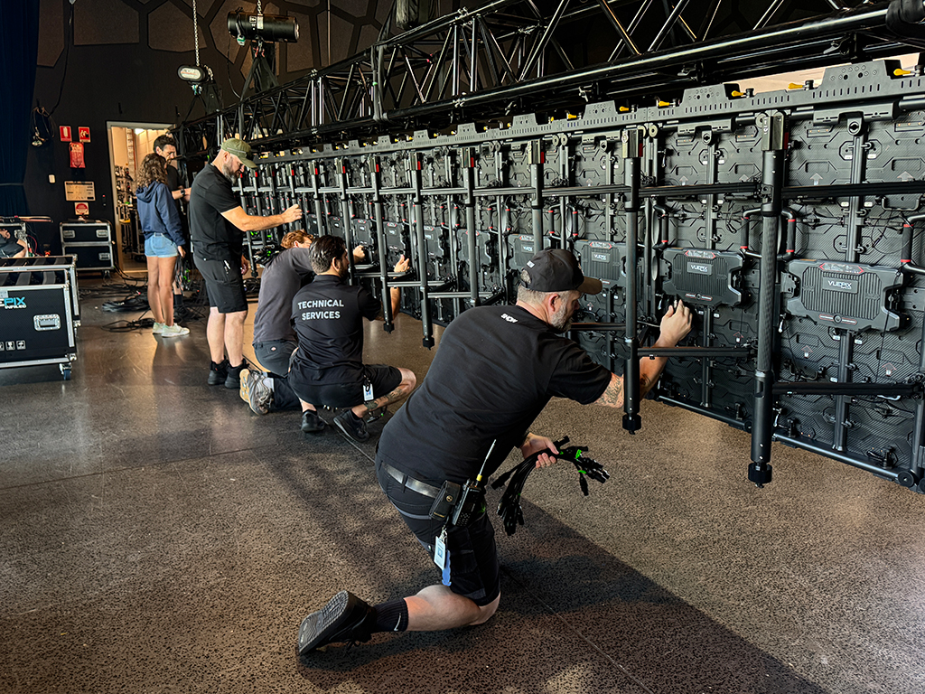 Crew assembling the rear of a VuePix LED screen at HOTA.