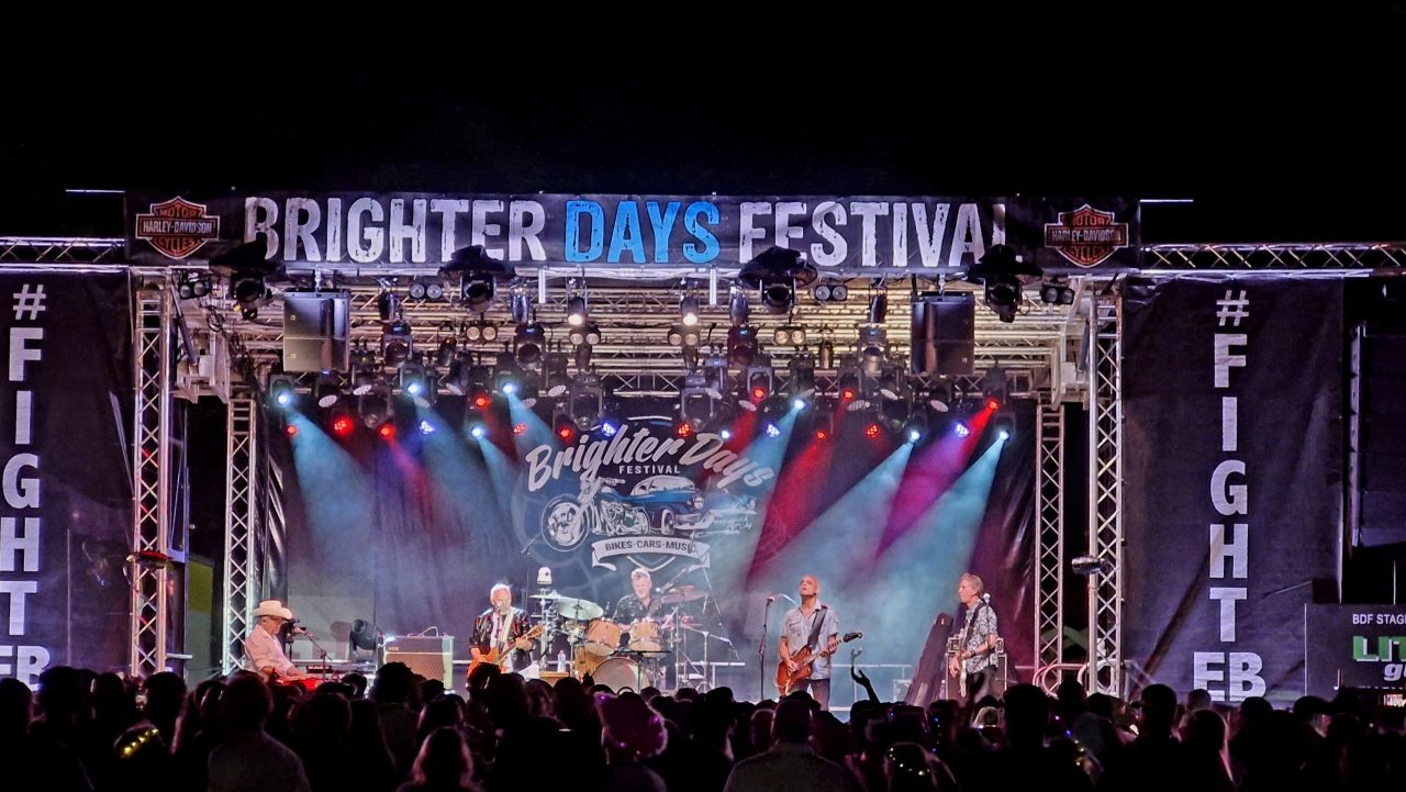 Brighter Days Festival 2025 stage with blue and red beams above the band.