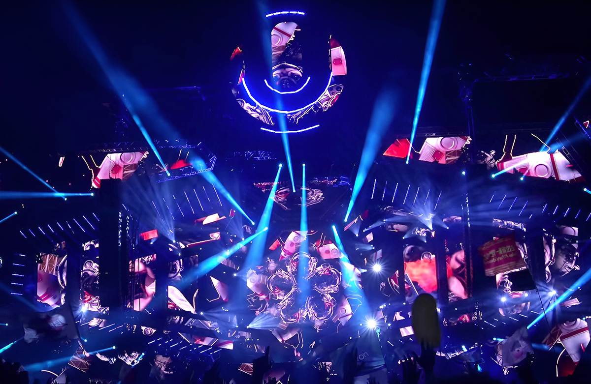 Overhead view of the Ultra Miami stage with blue beams and circular graphics.