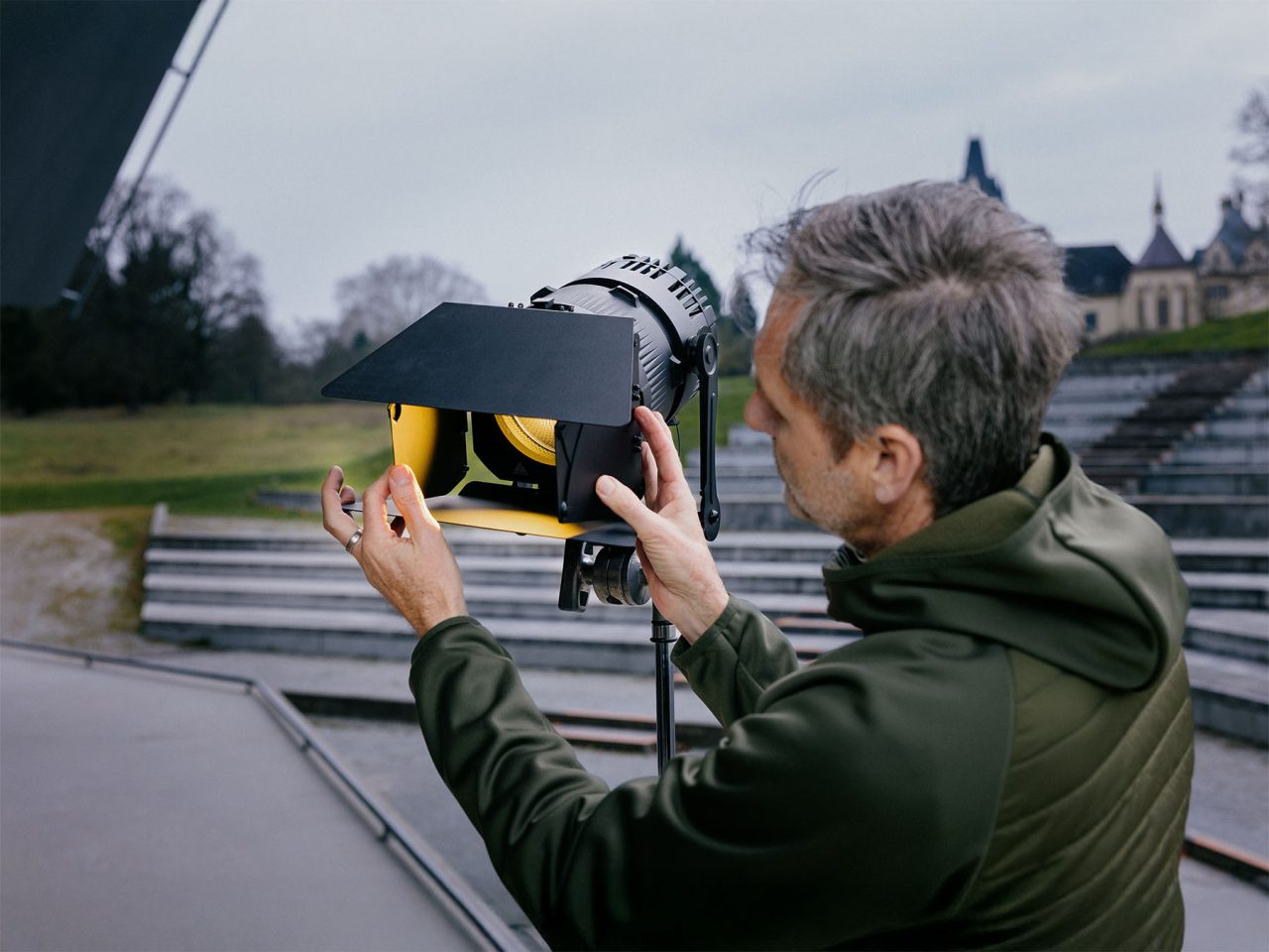 Person adjusting barn doors on an Astera QuikPunch outdoors.