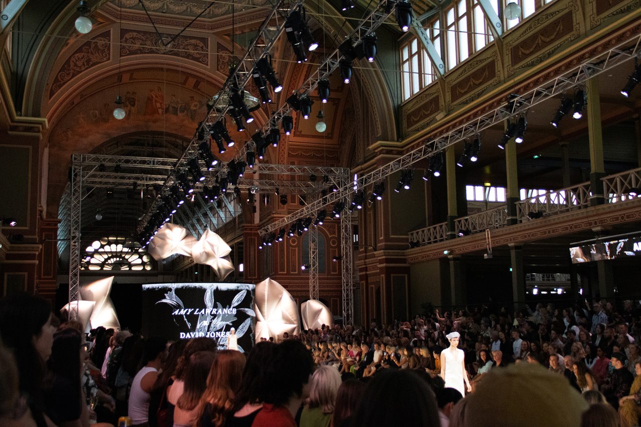 Fashion runway and overhead lighting inside the Royal Exhibition Building during the 2025 festival.