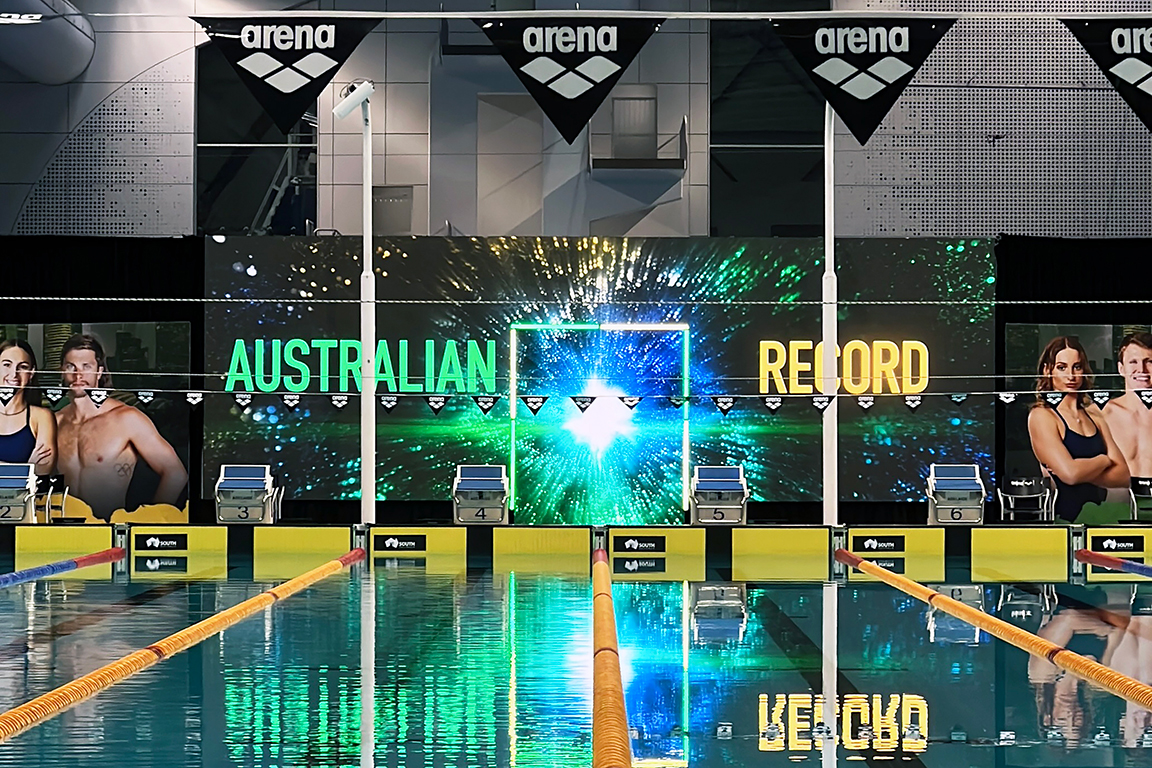 Australian Record graphics on the large poolside screen at the 2025 swimming trials.