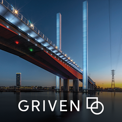 Griven branding beneath an illuminated bridge at dusk.