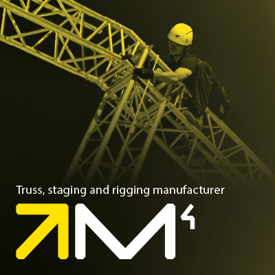 Milos branding beneath a technician working on a truss.