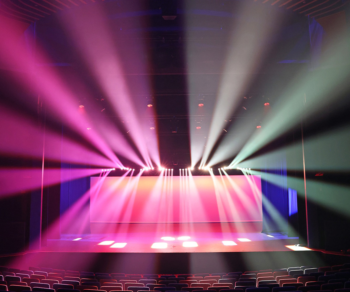 Fans of pink and white light above HOTA's theatre stage.
