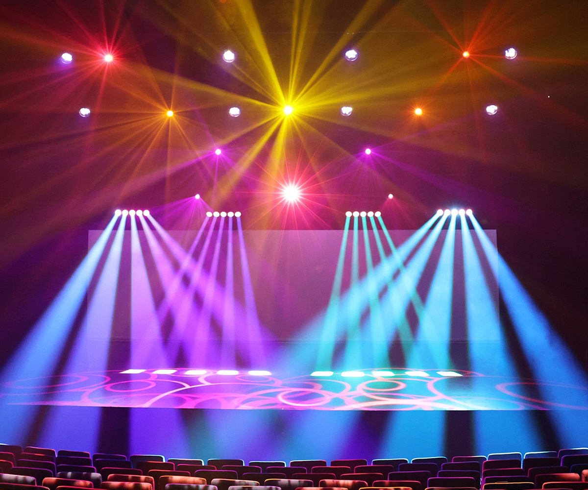 Colourful beams creating a rainbow lighting display in HOTA's theatre.
