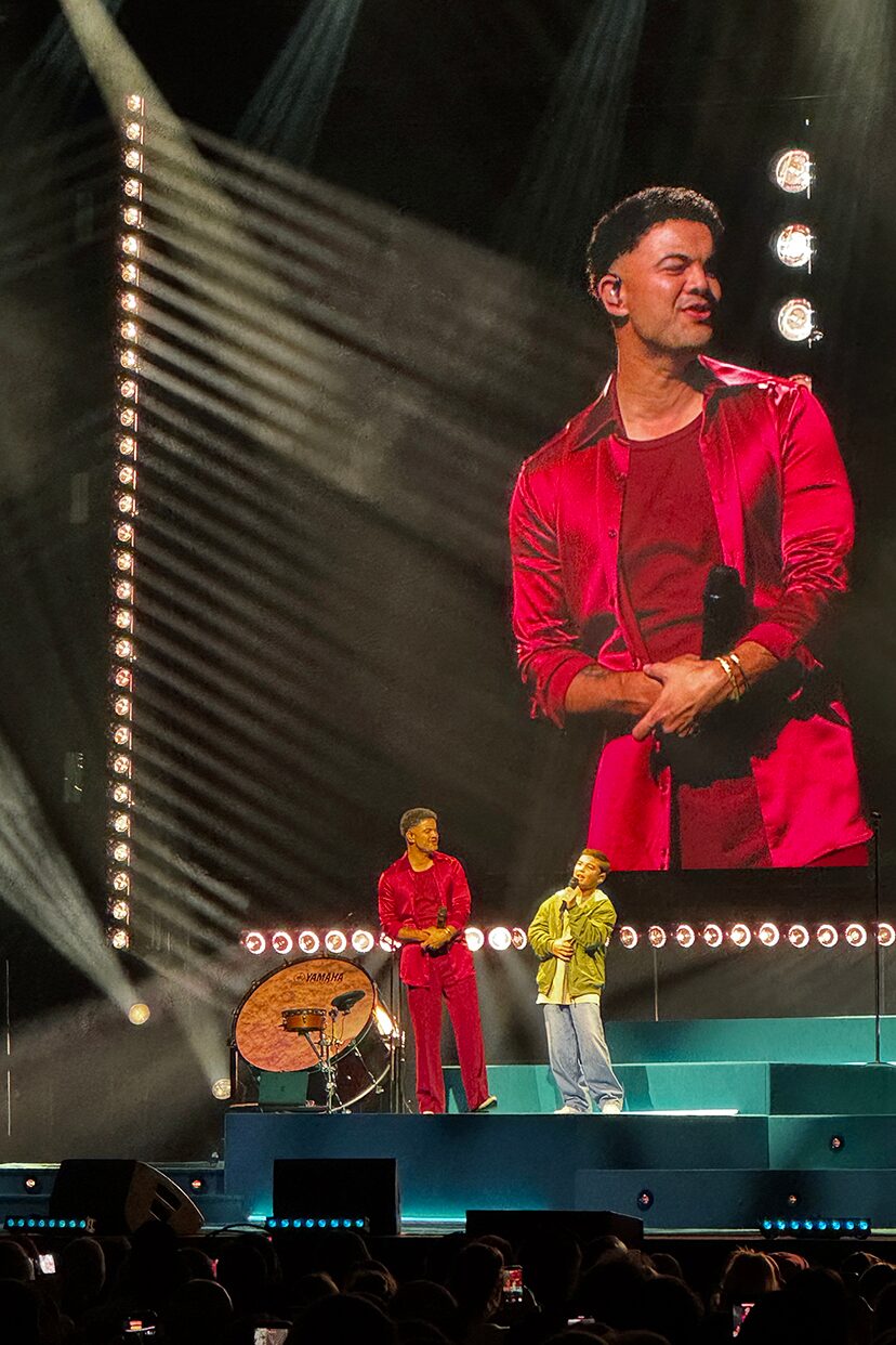 A tall live video screen above the stage during the 100 Times Around the Sun tour.
